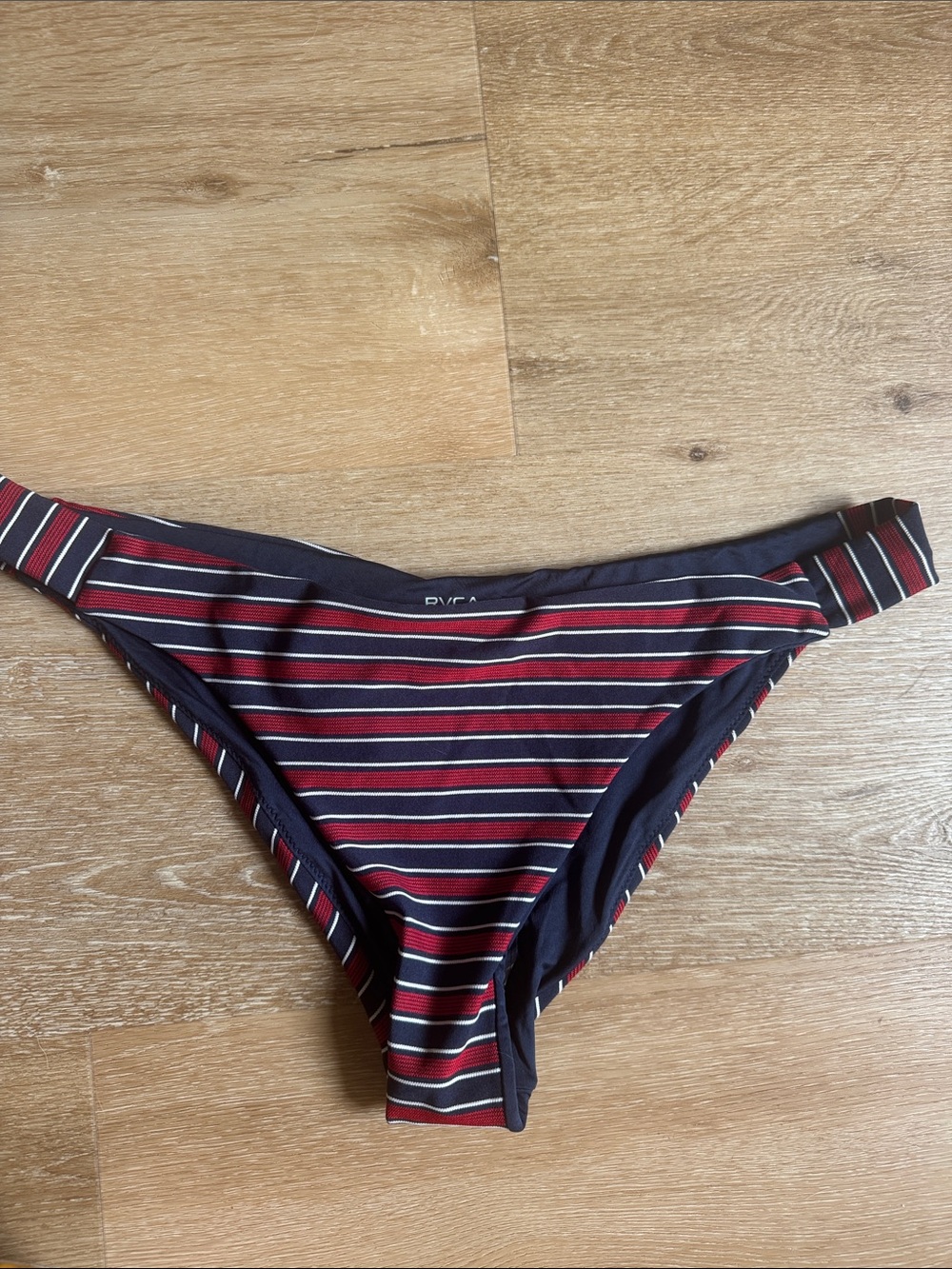New with tags RVCA navy and red striped bikini bottom. Size 12 or large.
